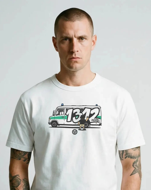 Man wearing a white ultras 1312 acab t-shirt with a graphic design on a plain background