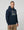 Man wearing a ultras away days navy hoodie with a graphic design on a light gray background