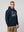 Man wearing a ultras away days navy hoodie with a graphic design on a light gray background