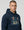 Man wearing a ultras away days navy hoodie with a graphic design on a light gray background