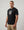 casual ultras wearing a black World Cup  t-shirt with a graphic design on a plain background
