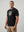 casual ultras wearing a black World Cup  t-shirt with a graphic design on a plain background
