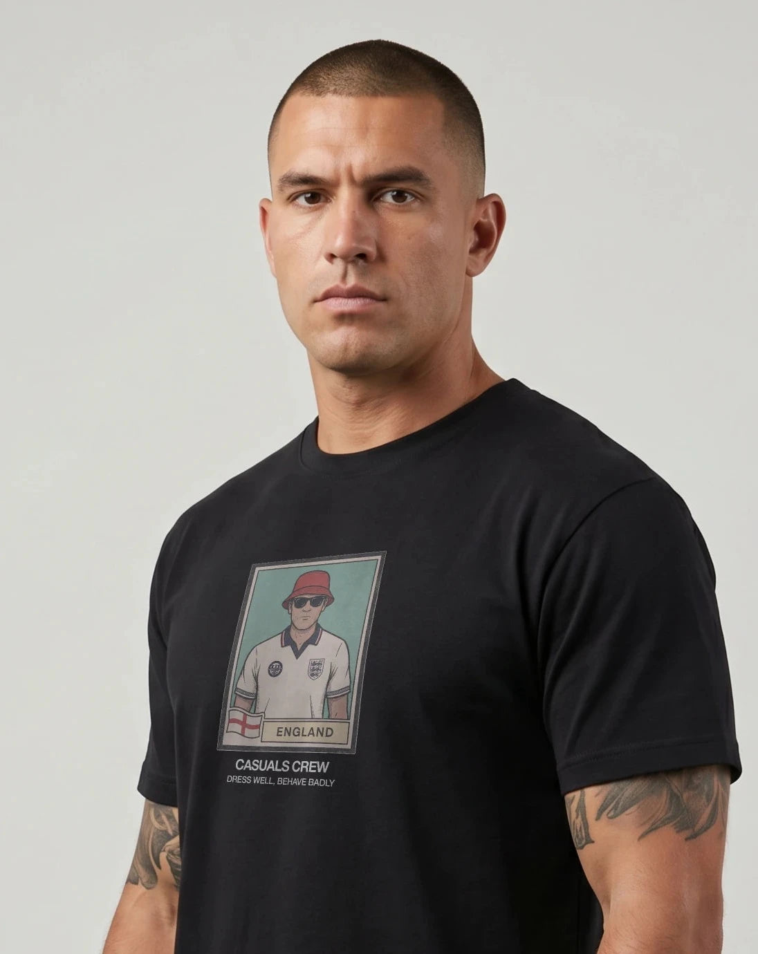 casuals ultras Man wearing a black England t-shirt with a graphic design on a plain background