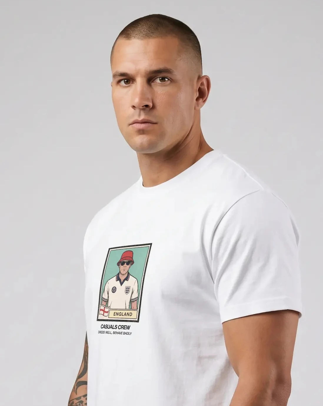 Casuals ultras Man wearing a white england World Cup t-shirt with a graphic design on a plain background