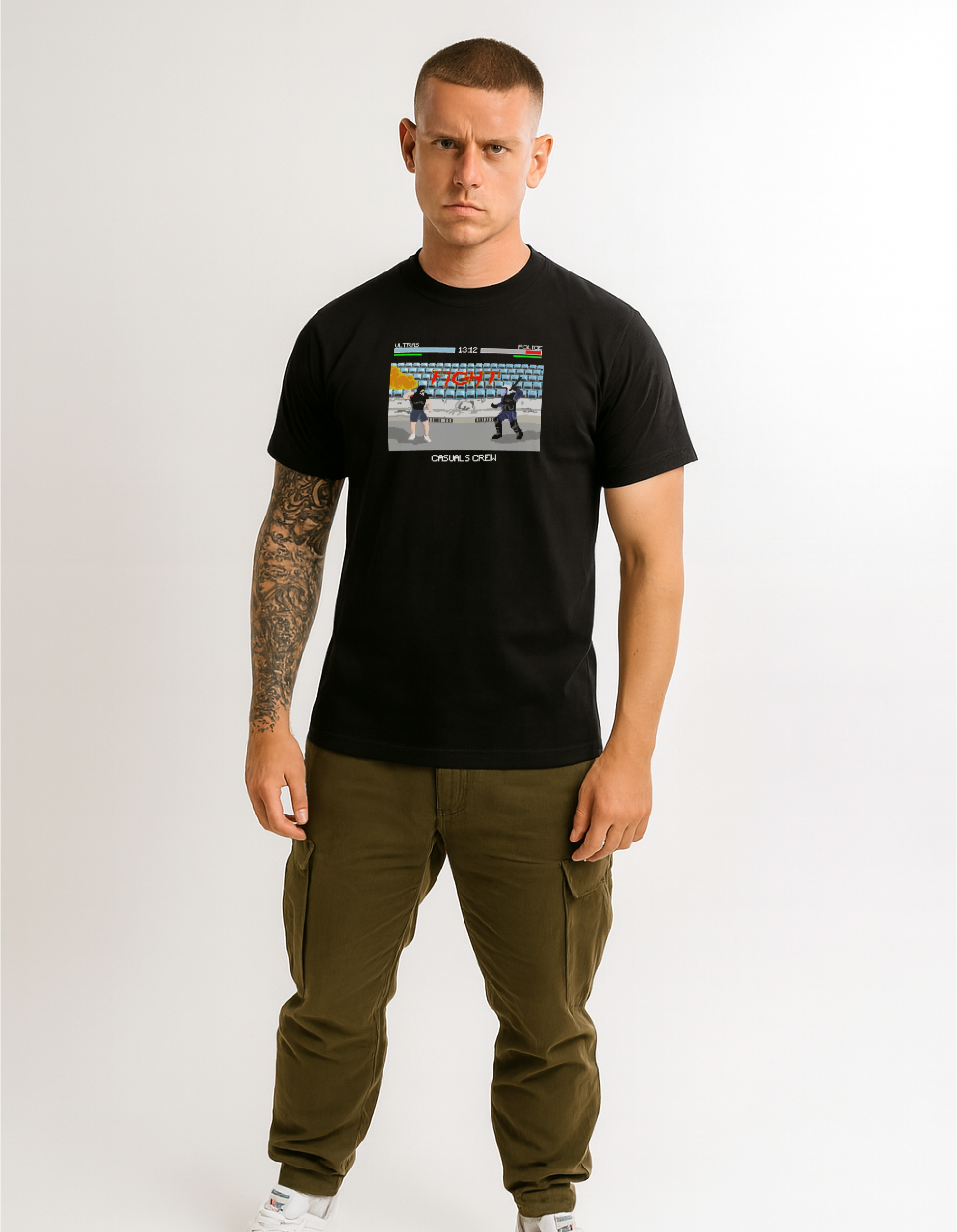 Man wearing a black t-shirt with a ultras vs acab graphic design and green pants on a white background