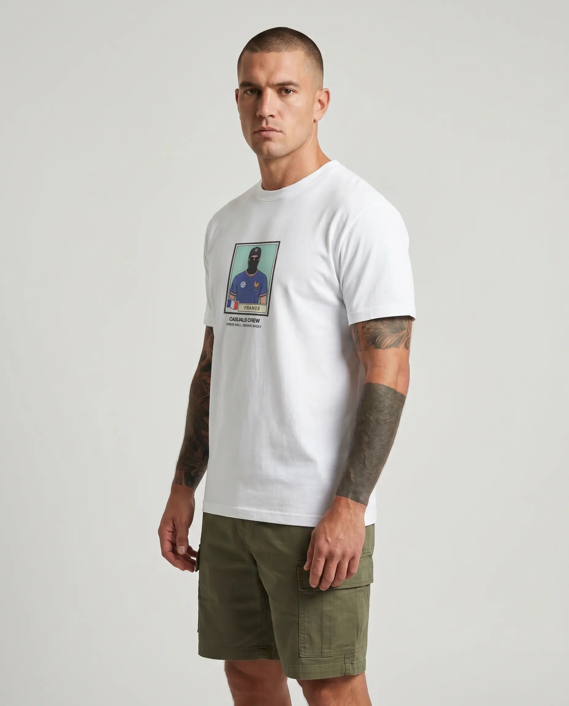 casuals ultras Man wearing a white France World Cup  t-shirt with a graphic design on a gray background