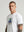 casuals ultras Man wearing a white France World Cup  t-shirt with a graphic design on a gray background