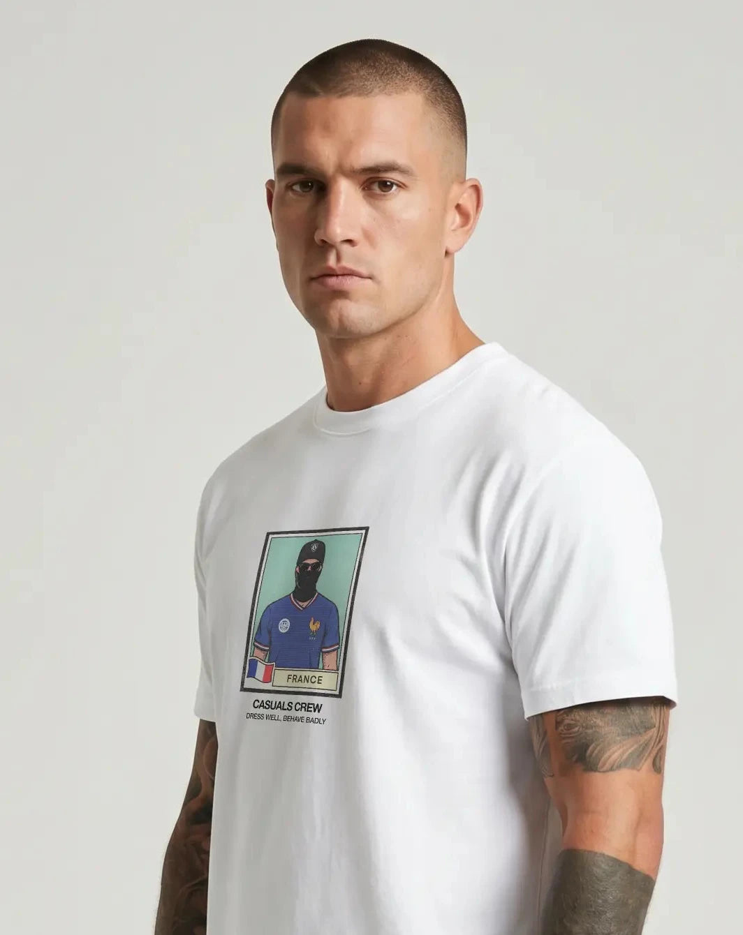 casuals ultras Man wearing a white France World Cup  t-shirt with a graphic design on a gray background
