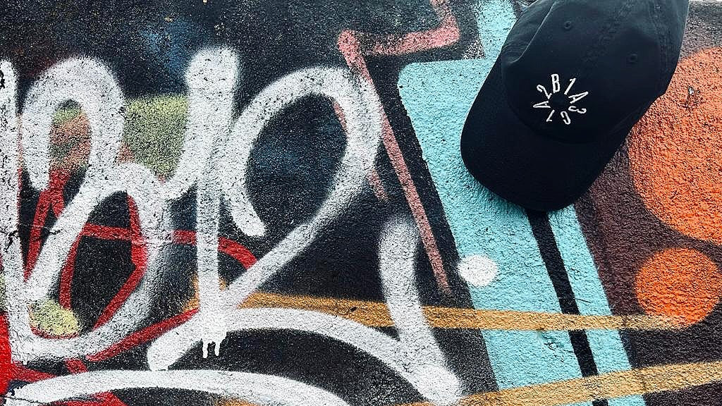 Graffiti 1312 art with numbers and abstract designs on a textured surface.
