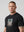 casuals ultras Man wearing a black Germany World Cup  t-shirt with a graphic design on a gray background