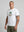 casuals ultras Man wearing a white Germany World Cup  t-shirt with a graphic design on a gray background