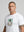 casuals ultras Man wearing a white Germany World Cup  t-shirt with a graphic design on a gray background