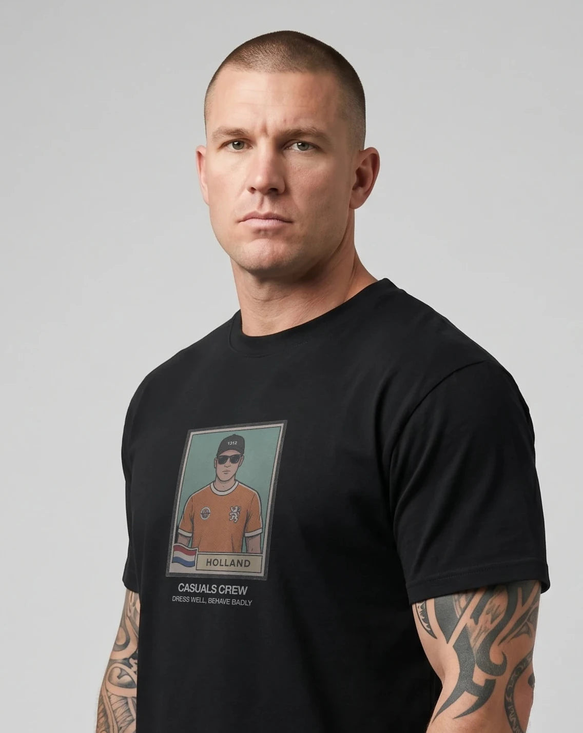 casuals ultras Man wearing a black Holland World Cup  t-shirt with a graphic design on a gray background