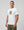casuals ultras Man wearing a white Holland World Cup  t-shirt with a graphic design on a gray background
