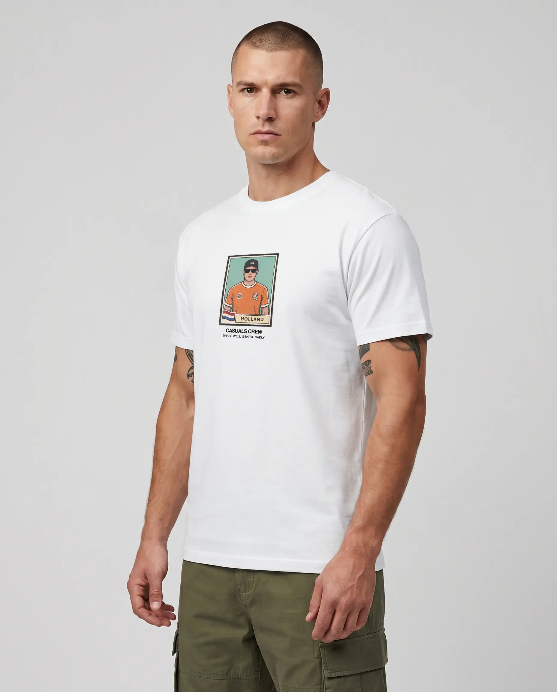 casuals ultras Man wearing a white Holland World Cup  t-shirt with a graphic design on a gray background