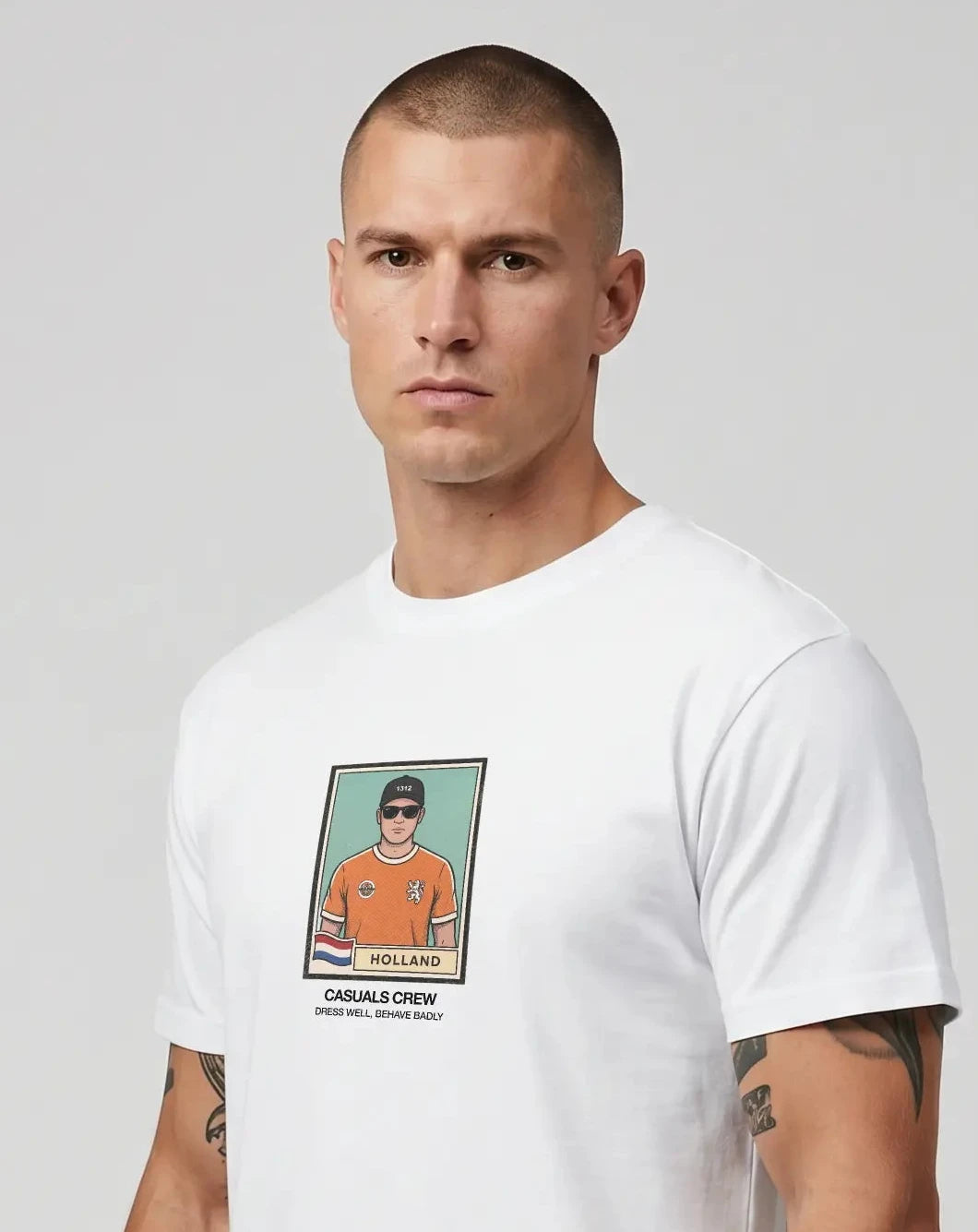 casuals ultras Man wearing a white Holland World Cup  t-shirt with a graphic design on a gray background