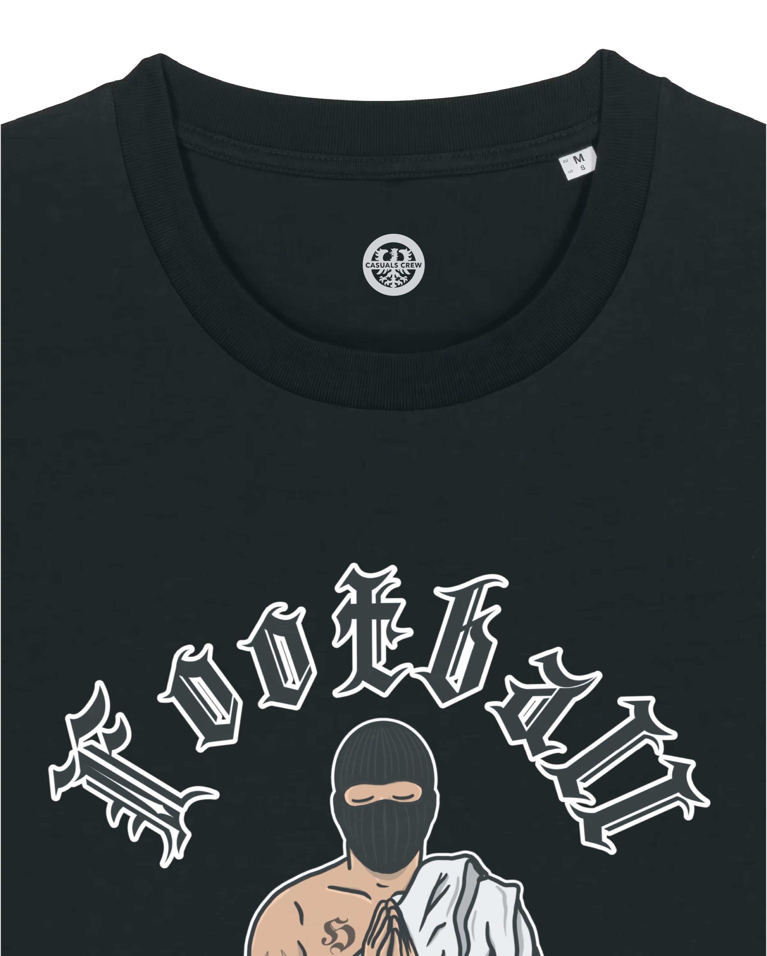 Black t-shirt with a graphic design of a person in a balaclava and robe, holding a football, with text above on a white background.