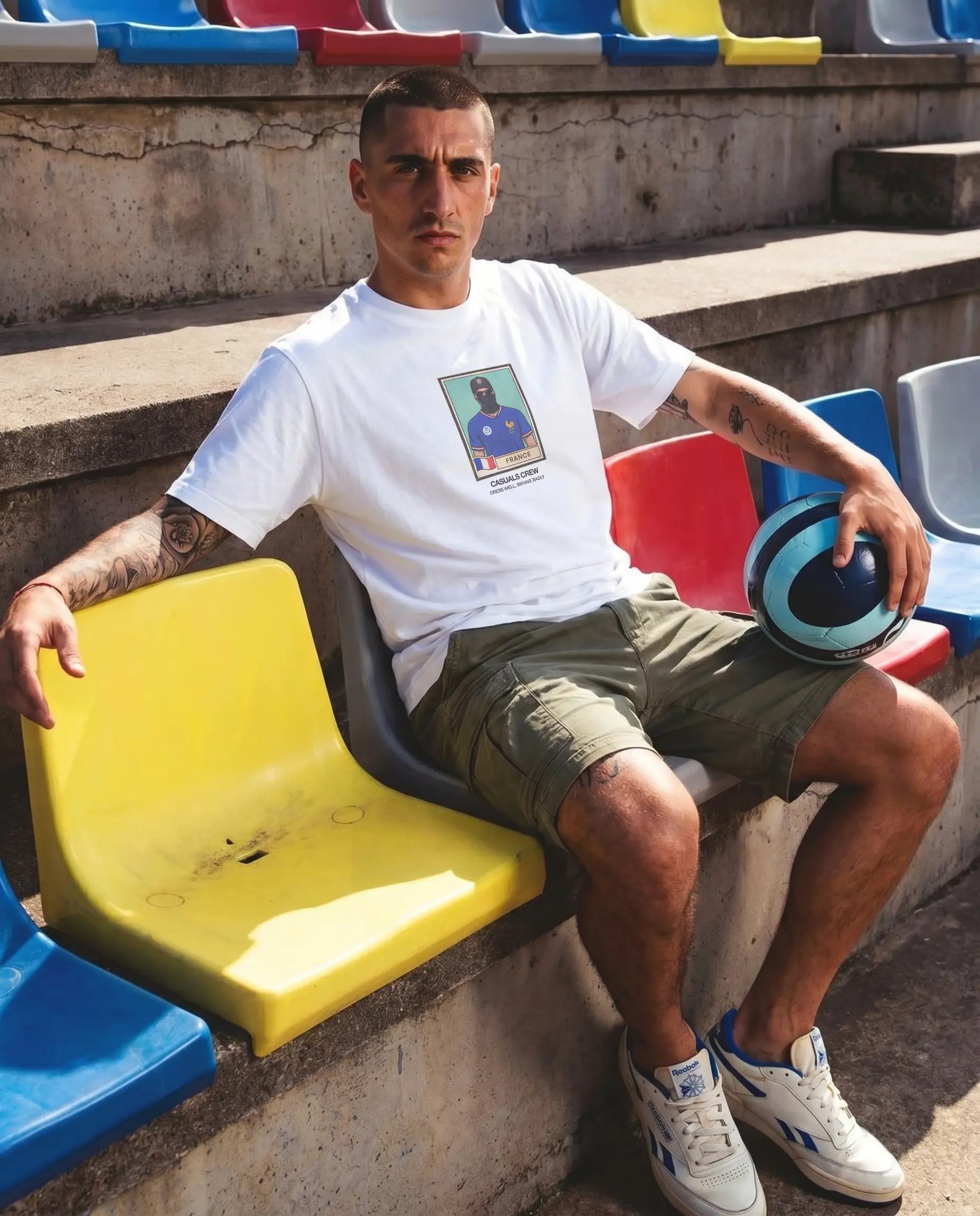 CASUALS ULTRAS World Cup Man sitting on a colorful bench in a stadium setting