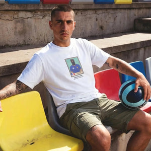 CASUALS ULTRAS World Cup Man sitting on a colorful bench in a stadium setting