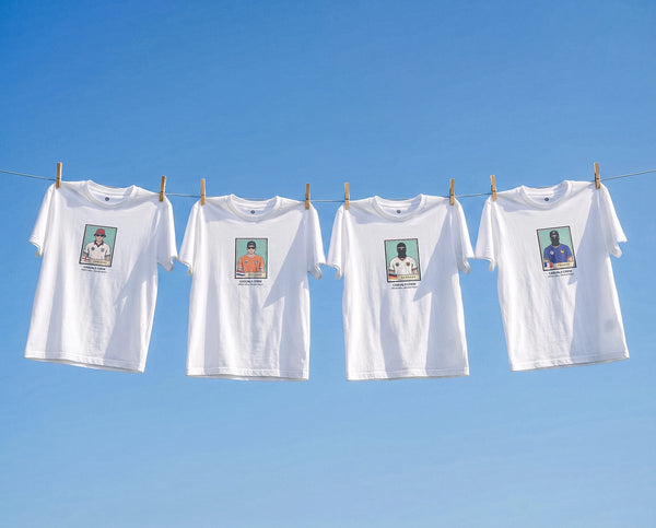 Four white WORLD CUP CASUALS ULTRAS t-shirts with printed images on a clothesline against a clear blue sky.